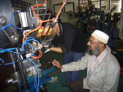 He is watching how technician adjusts his broom machine..jpg